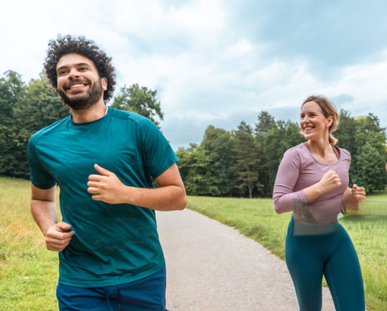 Three runners jogging together at the same pace on an urban trail