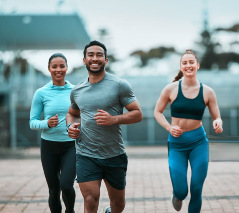 Four runners celebrating together after completing a run as a committed group