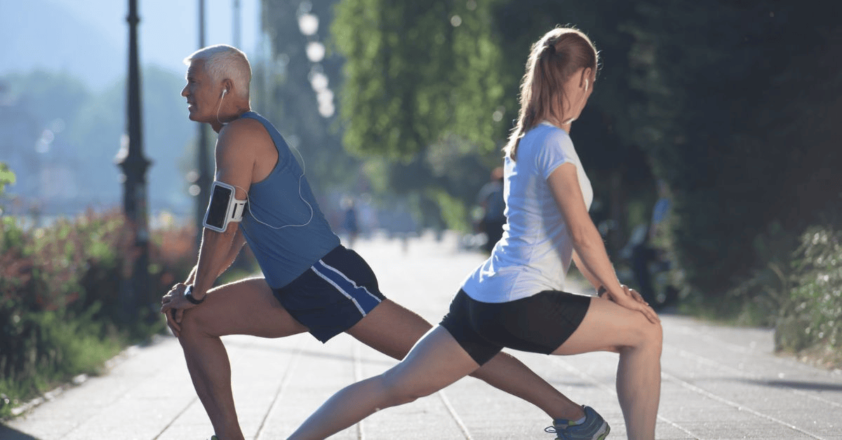 Runner performing dynamic warm-up stretches and drills before running