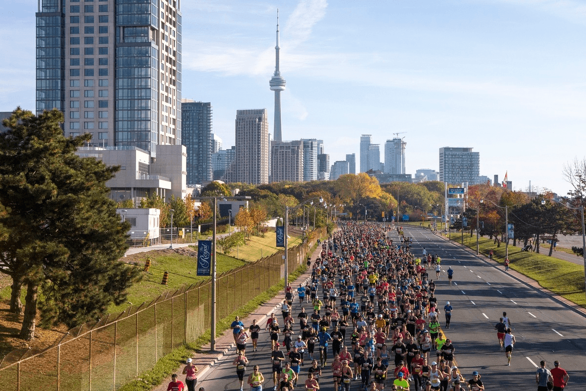 Runners on Toronto's Waterfront Trail with CN Tower in background